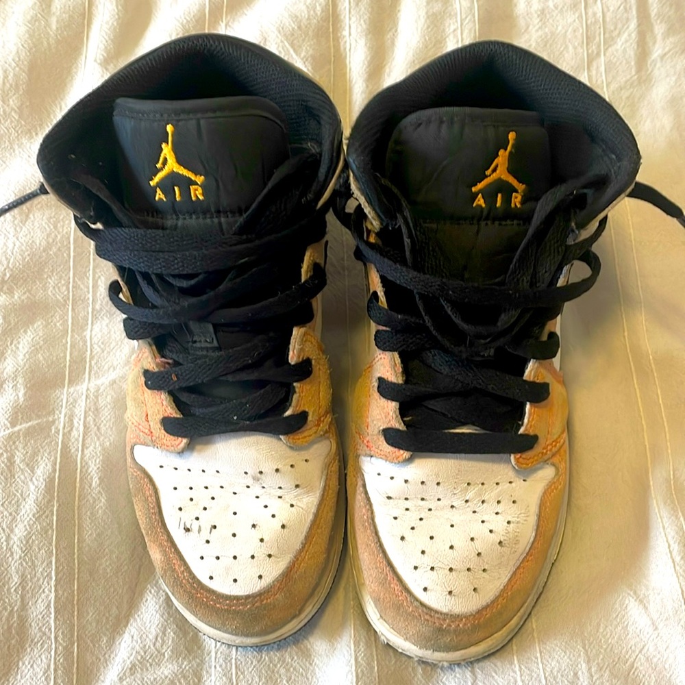 Black, pink, orange, and yellow high top Jordan’s